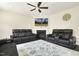 Cozy living room features leather couches, fireplace, ceiling fan and decor for comfortable living at 121 Martingale Dr, Holly Springs, NC 27540