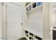 Mudroom featuring a white storage bench and shelves for shoe and coat organization near the entry door at 121 Martingale Dr, Holly Springs, NC 27540