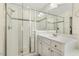 Bright primary bath featuring vanity, glass enclosed shower, and walk-in closet at 121 Martingale Dr, Holly Springs, NC 27540