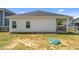 View of the fenced backyard and the house's exterior with two windows at 124 Boomer St, Benson, NC 27504