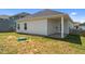 Spacious backyard featuring a covered patio, lush lawn, and privacy fencing at 124 Boomer St, Benson, NC 27504