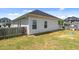 Image of the fenced backyard of the house, featuring a hose and green turtle toy at 124 Boomer St, Benson, NC 27504