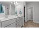 Bright bathroom featuring dual sinks, white cabinets, and tile flooring at 124 Boomer St, Benson, NC 27504