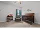 Inviting Bedroom featuring a crib, books, and a comfortable chair at 124 Boomer St, Benson, NC 27504