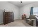 Comfortable Bedroom with cozy armchair and dark wood dresser at 124 Boomer St, Benson, NC 27504