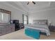 Comfortable bedroom with tray ceiling, dresser, gray toned walls, and blue accent chest at 124 Boomer St, Benson, NC 27504
