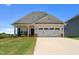 Charming single-Gathering home featuring a well-maintained lawn and an attached two-car garage at 124 Boomer St, Benson, NC 27504