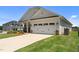 Attractive home with a two-car garage and a neatly landscaped front yard at 124 Boomer St, Benson, NC 27504