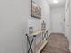 Inviting hallway featuring wood-look flooring and decoratively appointed console table with a rustic painting at 124 Boomer St, Benson, NC 27504