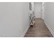 Bright hallway with wood floors and a decorative console table near the front door at 124 Boomer St, Benson, NC 27504