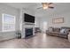 Comfortable living room with a fireplace, TV, and access to the backyard at 124 Boomer St, Benson, NC 27504