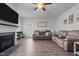 Spacious living room with hardwood floors, a fireplace, and access to the backyard at 124 Boomer St, Benson, NC 27504