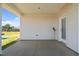 Covered back patio with access to the backyard featuring playground equipment at 124 Boomer St, Benson, NC 27504