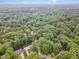 Aerial view of a neighborhood surrounded by mature trees at 125 Amesbury Ln, Cary, NC 27511