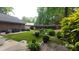Back yard featuring a well-maintained artificial lawn and a comfortable outdoor seating area at 125 Amesbury Ln, Cary, NC 27511