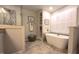 Modern bathroom with a soaking tub, tiled floors, and a glass-enclosed shower at 125 Amesbury Ln, Cary, NC 27511