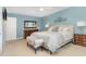 Calm, blue bedroom features a light upholstered bed and neutral accents at 125 Amesbury Ln, Cary, NC 27511