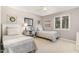 This bedroom offers two beds, natural light, and farmhouse decor at 125 Amesbury Ln, Cary, NC 27511