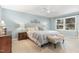 Calm, blue bedroom with a light upholstered bed, wood dresser, and a ceiling fan at 125 Amesbury Ln, Cary, NC 27511
