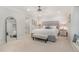 Neutral bedroom features a gray upholstered bed and bench with white trim at 125 Amesbury Ln, Cary, NC 27511