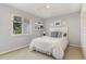 Neutral bedroom features a ceiling fan, window views, wall shelves, and charming nautical decorations at 125 Amesbury Ln, Cary, NC 27511