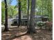 Traditional-style home nestled among mature trees with a spacious, landscaped front yard at 125 Amesbury Ln, Cary, NC 27511