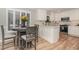 Cozy kitchen featuring modern appliances, bar seating, and natural light at 125 Amesbury Ln, Cary, NC 27511