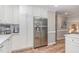 Bright kitchen features stainless steel refrigerator and ample white cabinetry at 125 Amesbury Ln, Cary, NC 27511