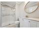 Updated bathroom with glass door shower, tiled walls and floors and modern finishes at 1304 Greenside Dr, Raleigh, NC 27609