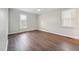 Neutral bedroom with ceiling fan and natural light from two windows at 1304 Greenside Dr, Raleigh, NC 27609