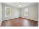 Large bedroom featuring two windows and neutral wall color at 1304 Greenside Dr, Raleigh, NC 27609