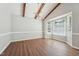 Dining room featuring hardwood floors, a large window, and beamed ceilings at 1304 Greenside Dr, Raleigh, NC 27609