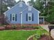 Charming blue house featuring dark blue shutters and nicely landscaped yard at 1304 Greenside Dr, Raleigh, NC 27609