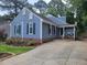 Stylish blue house with a cozy front porch and a long driveway at 1304 Greenside Dr, Raleigh, NC 27609