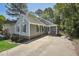 Charming one-story home with blue siding, shutters, a well-maintained lawn and a driveway at 1304 Greenside Dr, Raleigh, NC 27609
