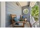 Inviting front porch with seating, blue pillows, and view of the greenery at 1304 Greenside Dr, Raleigh, NC 27609