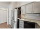 Updated kitchen featuring stainless steel refrigerator, granite countertops, and gray cabinets at 1304 Greenside Dr, Raleigh, NC 27609