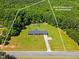 Aerial view of property lines showcasing a ranch style home surrounded by lush trees and a long driveway at 137 Vaiden Rd, Louisburg, NC 27549