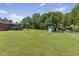 View of a well-maintained lawn, house, and detached garage at 137 Vaiden Rd, Louisburg, NC 27549