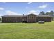 This is a backyard with a well-maintained lawn and brick house at 137 Vaiden Rd, Louisburg, NC 27549