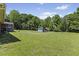The backyard features a spacious, well-manicured lawn and trees at 137 Vaiden Rd, Louisburg, NC 27549