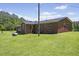 Brick house sits on a large lot with well-maintained lawn at 137 Vaiden Rd, Louisburg, NC 27549