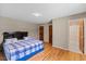 Cozy bedroom featuring hardwood floors and a comfortable bed with blue and white patterned bedding at 137 Vaiden Rd, Louisburg, NC 27549