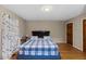 Comfortable bedroom featuring a bed with blue patterned bedding and neutral colored walls at 137 Vaiden Rd, Louisburg, NC 27549