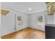 This is a well-lit bedroom with hardwood floors and two windows at 137 Vaiden Rd, Louisburg, NC 27549