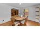 Bright dining room featuring hardwood floors, natural light, and an adjacent entry to another room at 137 Vaiden Rd, Louisburg, NC 27549