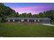 Charming single-story brick home with an attached two-car garage and well-manicured front lawn at 137 Vaiden Rd, Louisburg, NC 27549