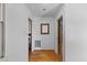 Bright hallway with hardwood floors and white walls, leading to various rooms in the home at 137 Vaiden Rd, Louisburg, NC 27549
