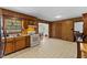 Well-lit kitchen featuring light appliances and an opening to the dining area at 137 Vaiden Rd, Louisburg, NC 27549