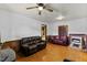 Spacious living room featuring hardwood floors and comfortable leather seating at 137 Vaiden Rd, Louisburg, NC 27549